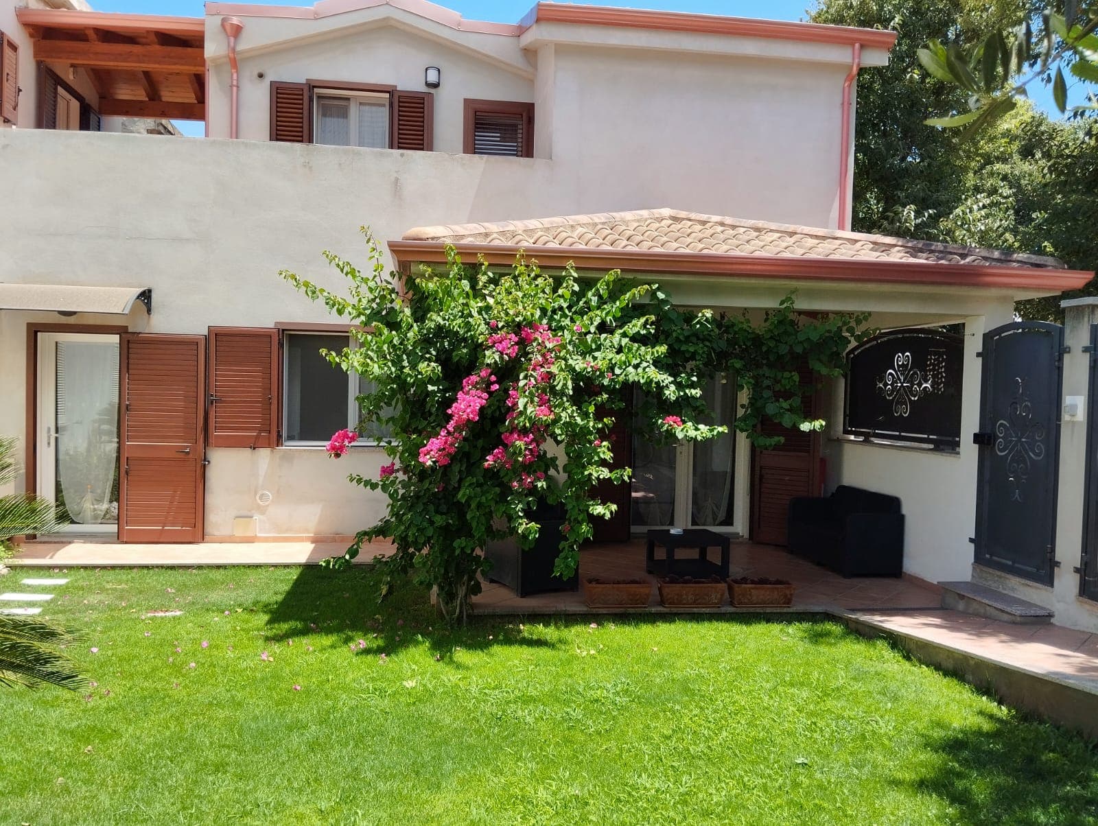 Table with seats outside a small villa